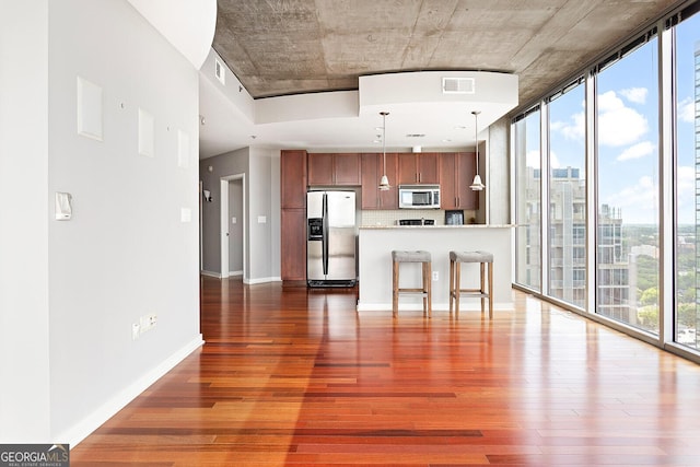 855 Peachtree St NE Unit 2203, Atlanta, GA 30308 - unfurnished living room with wood finished floors, expansive windows, and baseboards