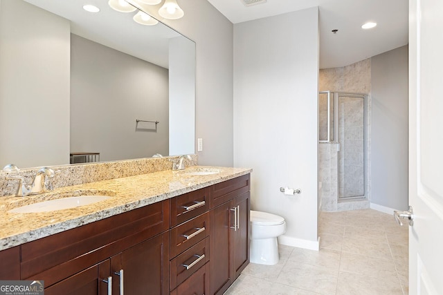 855 Peachtree St NE Unit 2203, Atlanta, GA 30308 - bathroom featuring a shower stall, toilet, double vanity, tile patterned floors, and baseboards