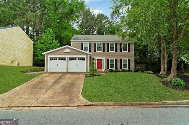 colonial inspired home featuring a garage, a front yard, and driveway