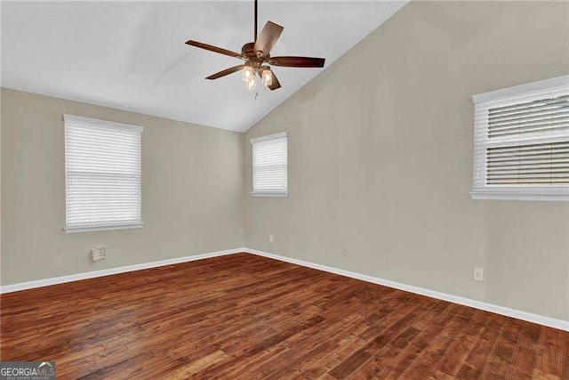 spare room with ceiling fan, wood finished floors, baseboards, and high vaulted ceiling