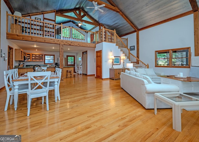 142 Hugh Dorsey Rd, Hartwell, GA 30643 - living area featuring high vaulted ceiling, light wood finished floors, ceiling fan, stairway, and baseboards