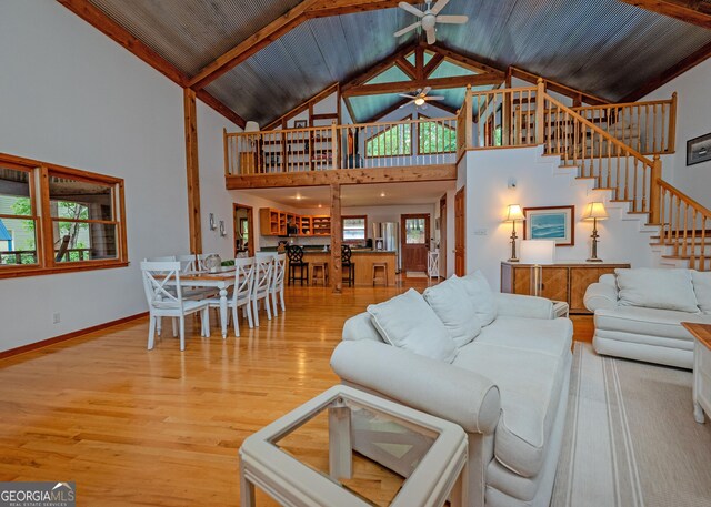 142 Hugh Dorsey Rd, Hartwell, GA 30643 - living area featuring ceiling fan, wood finished floors, high vaulted ceiling, stairway, and baseboards