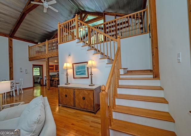 142 Hugh Dorsey Rd, Hartwell, GA 30643 - stairway with ceiling fan, wood finished floors, high vaulted ceiling, and beamed ceiling
