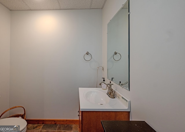 142 Hugh Dorsey Rd, Hartwell, GA 30643 - bathroom featuring baseboards, vanity, toilet, and a paneled ceiling