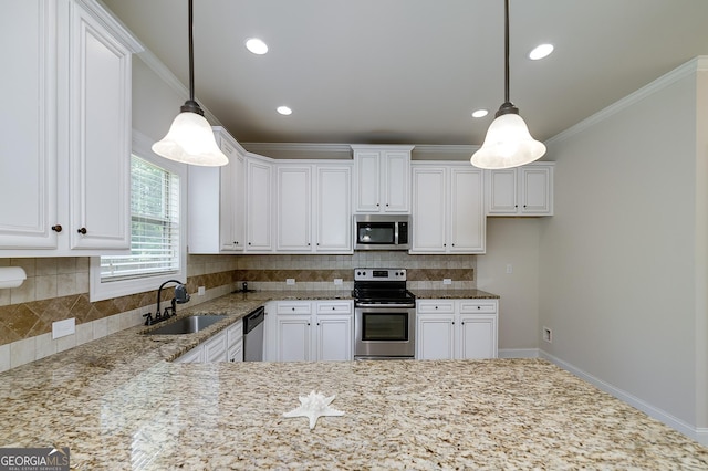 kitchen featuring stainless steel appliances, a sink, light stone counters, white cabinets, and recessed lighting