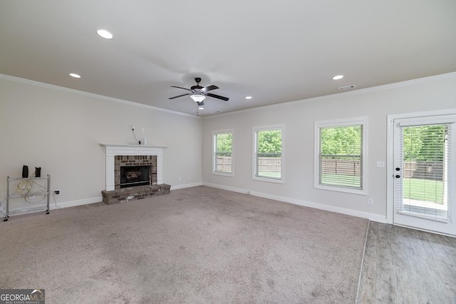 unfurnished living room featuring ceiling fan, a fireplace, ornamental molding, baseboards, and recessed lighting