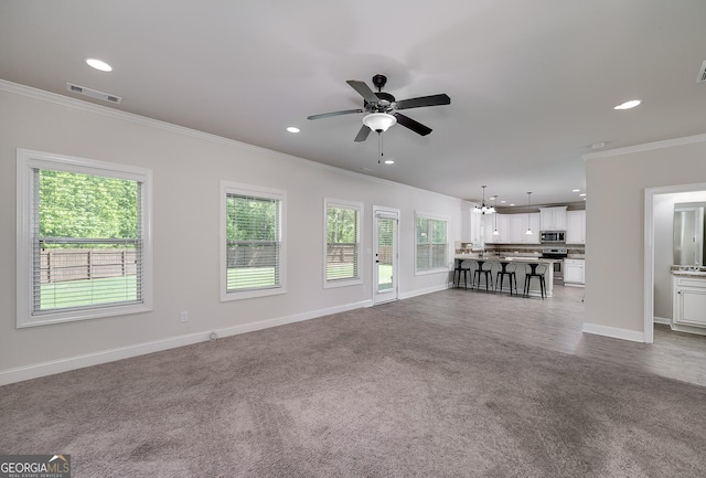 living room with crown molding, a ceiling fan, recessed lighting, baseboards, and carpet floors