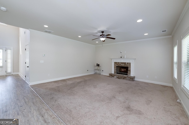 unfurnished living room featuring ceiling fan, ornamental molding, recessed lighting, baseboards, and a fireplace