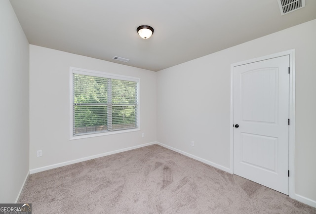 carpeted empty room with baseboards