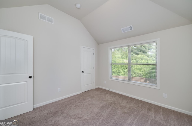 unfurnished bedroom featuring lofted ceiling, carpet floors, and baseboards