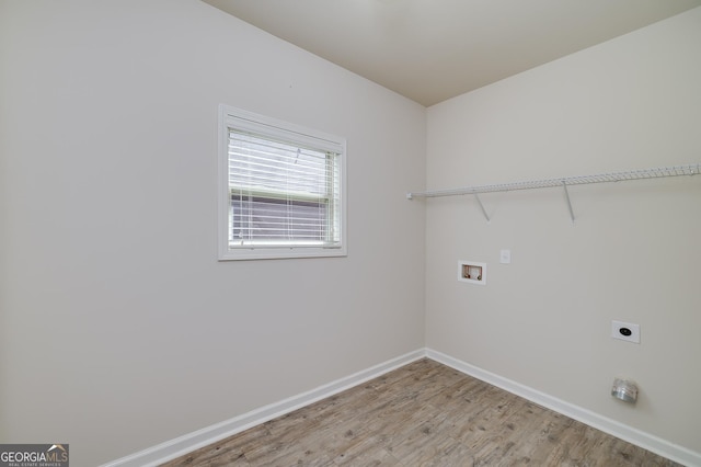 laundry room featuring hookup for an electric dryer, light wood-style flooring, baseboards, and hookup for a washing machine