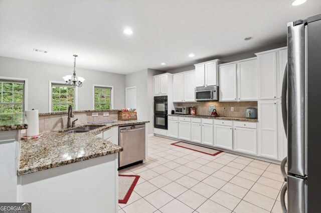4960 Tadmore Ln, Lithonia, GA 30038 - kitchen featuring black appliances, a sink, tasteful backsplash, white cabinets, and recessed lighting