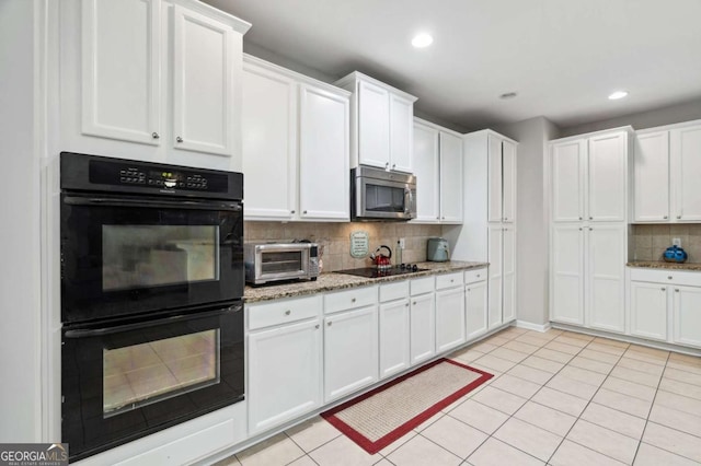 4960 Tadmore Ln, Lithonia, GA 30038 - kitchen with black appliances, backsplash, recessed lighting, white cabinets, and light stone counters