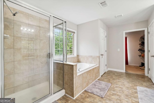 4960 Tadmore Ln, Lithonia, GA 30038 - full bathroom with a shower stall, a garden tub, and baseboards