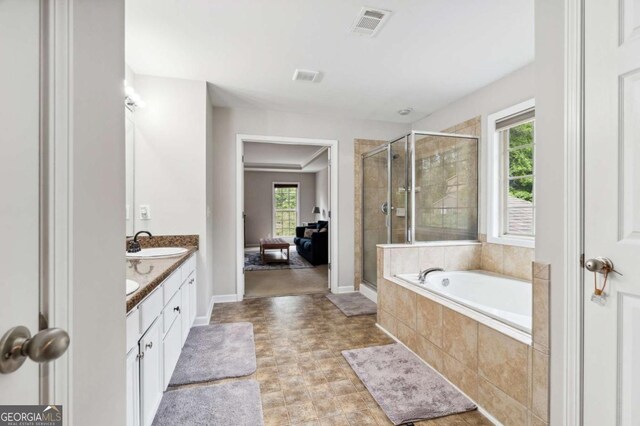4960 Tadmore Ln, Lithonia, GA 30038 - bathroom with plenty of natural light, a stall shower, double vanity, and a bath