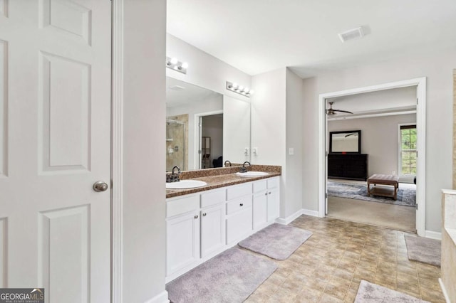 4960 Tadmore Ln, Lithonia, GA 30038 - full bathroom featuring a ceiling fan, a stall shower, double vanity, and baseboards