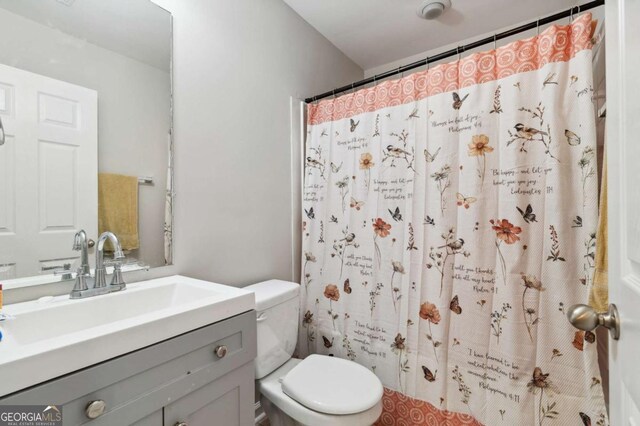 4960 Tadmore Ln, Lithonia, GA 30038 - bathroom with vanity, toilet, and curtained shower