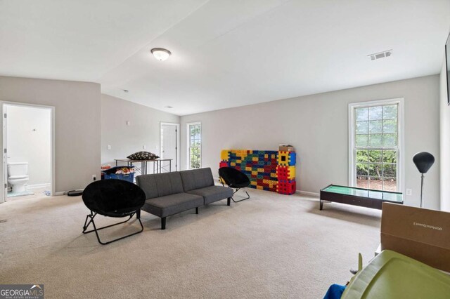 4960 Tadmore Ln, Lithonia, GA 30038 - carpeted living area with lofted ceiling and baseboards