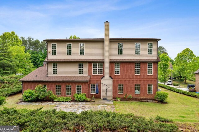 4960 Tadmore Ln, Lithonia, GA 30038 - view of front of property featuring a chimney, a front yard, and brick siding
