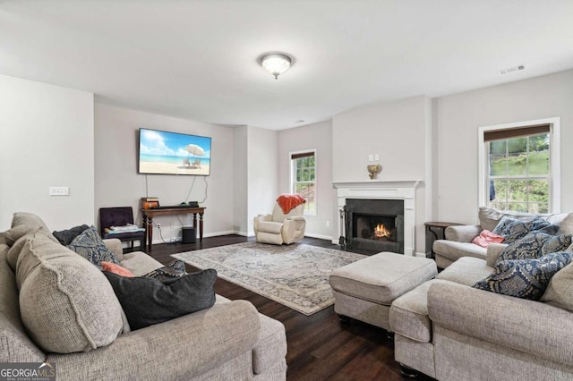 4960 Tadmore Ln, Lithonia, GA 30038 - living area featuring dark wood-style floors, a fireplace with flush hearth, and baseboards