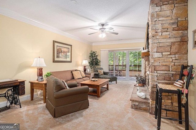 living room featuring light carpet, crown molding, a ceiling fan, a textured ceiling, and baseboards