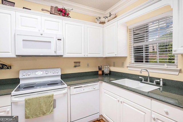kitchen with white appliances, a sink, white cabinets, and crown molding