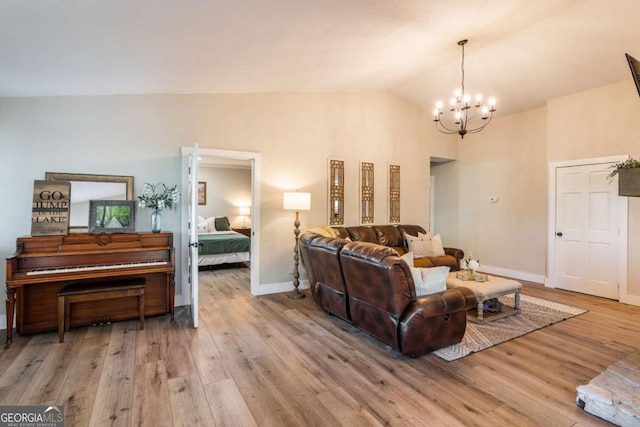138 Mccombs Dr Unit 7, Blairsville, GA 30512 - living area featuring a chandelier, light wood-style floors, baseboards, and vaulted ceiling