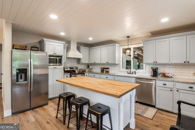138 Mccombs Dr Unit 7, Blairsville, GA 30512 - kitchen featuring stainless steel appliances, custom exhaust hood, a sink, wood counters, and tasteful backsplash