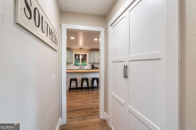 138 Mccombs Dr Unit 7, Blairsville, GA 30512 - corridor featuring recessed lighting, wood finished floors, a textured wall, and a sink