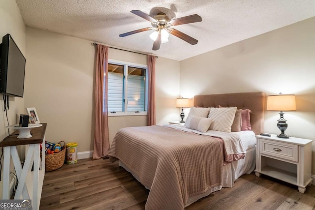 138 Mccombs Dr Unit 7, Blairsville, GA 30512 - bedroom with wood finished floors, a textured ceiling, baseboards, and a ceiling fan