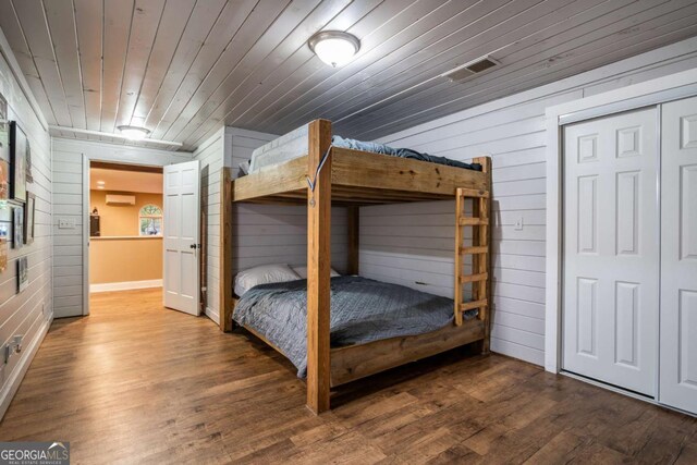 138 Mccombs Dr Unit 7, Blairsville, GA 30512 - bedroom featuring wooden walls, a wall unit AC, wood finished floors, and wooden ceiling