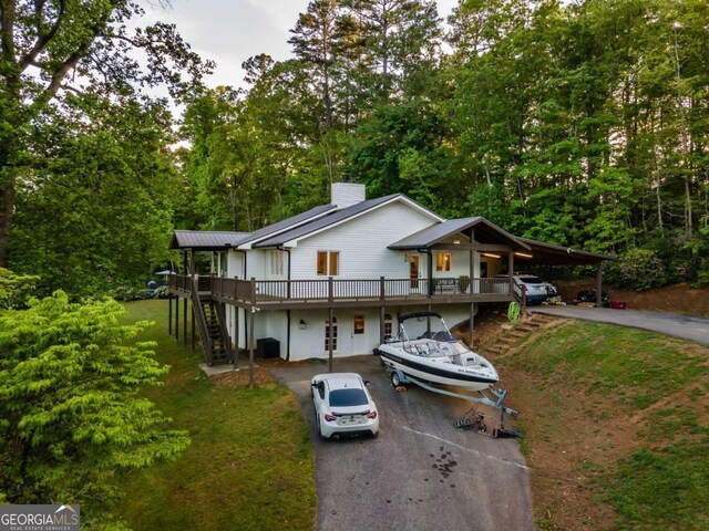 138 Mccombs Dr Unit 7, Blairsville, GA 30512 - view of front facade with driveway, stairway, a chimney, and a wooden deck