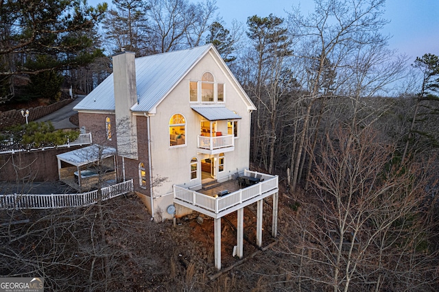 626 Palisade Dr, Ellijay, GA 30540 - rear view of house with a balcony, a metal roof, and a chimney