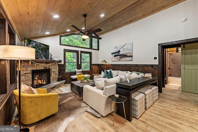 living room featuring wainscoting, vaulted ceiling, wooden ceiling, wood finished floors, and a ceiling fan