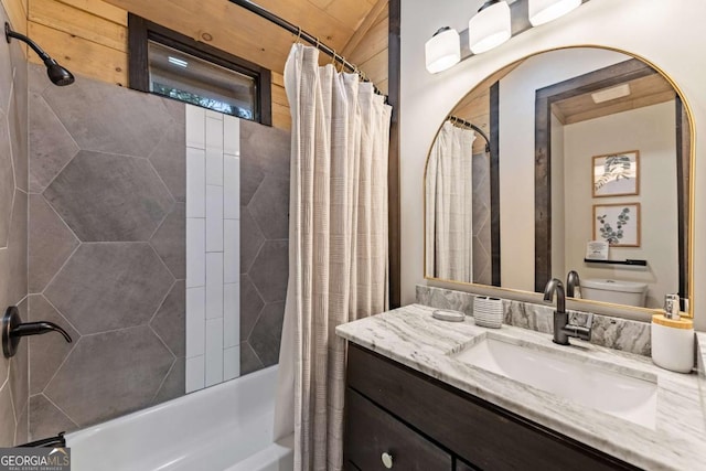 bathroom featuring vanity, shower / bathtub combination with curtain, and toilet