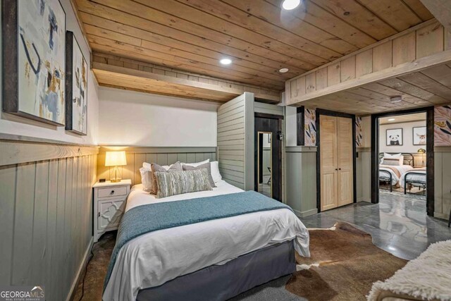 bedroom featuring wood ceiling, recessed lighting, wainscoting, and wooden walls