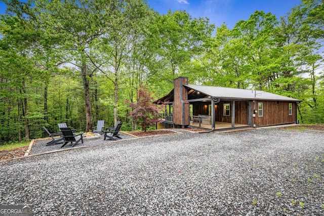 view of front of property featuring an outdoor fire pit and a chimney