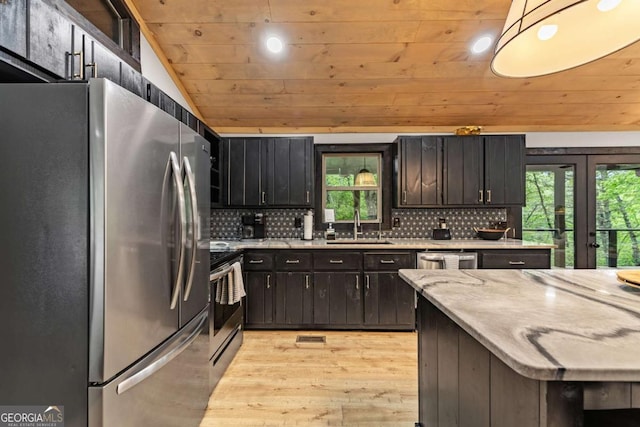 kitchen featuring appliances with stainless steel finishes, wooden ceiling, light wood-style floors, healthy amount of natural light, and a sink