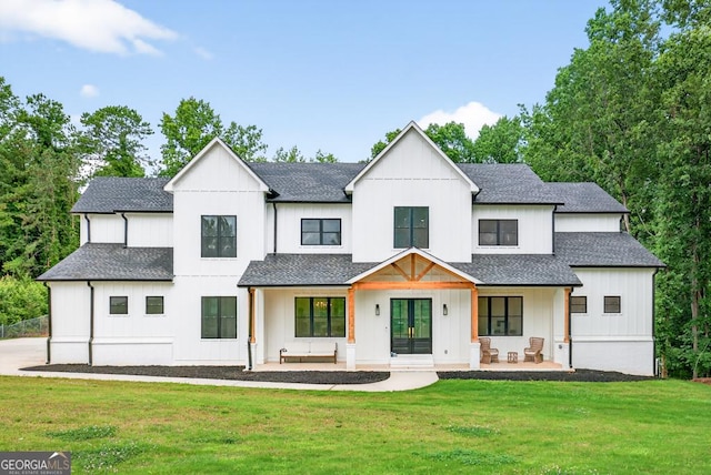 3180 Lee Dr, Buford, GA 30518 - modern farmhouse style home with french doors, a front lawn, a shingled roof, and board and batten siding