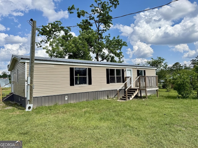101 S Taylor, Nicholls, GA 31554 - manufactured / mobile home featuring a front yard and a deck