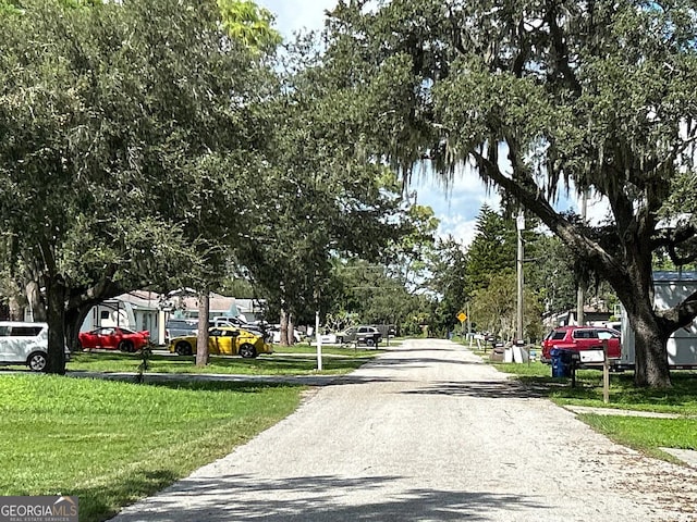 view of asphalt street featuring traffic signs