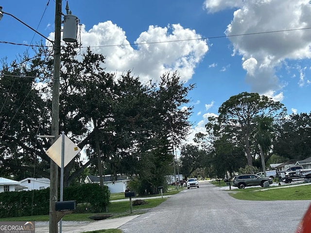 view of asphalt road featuring traffic signs