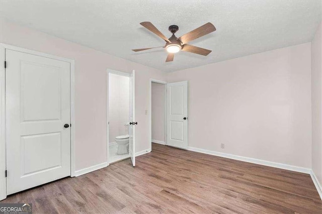 unfurnished bedroom with light wood finished floors, baseboards, and ceiling fan