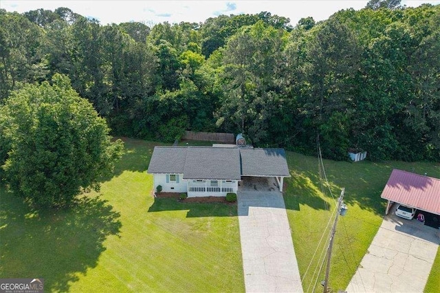 aerial view of property and surrounding area with a forest