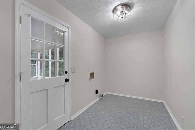 laundry area featuring a textured ceiling, carpet floors, washer hookup, and baseboards
