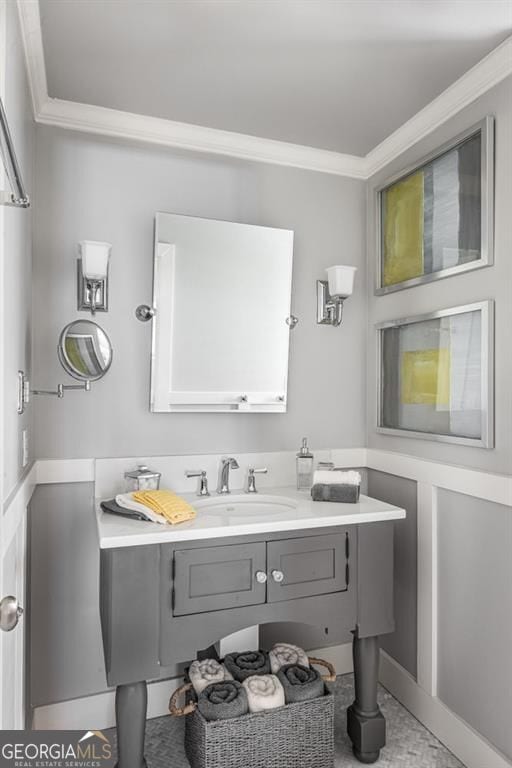 bathroom with crown molding and vanity