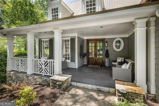 entrance to property with french doors and a porch