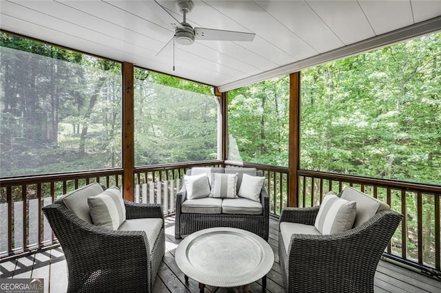 sunroom featuring ceiling fan and an outdoor living space