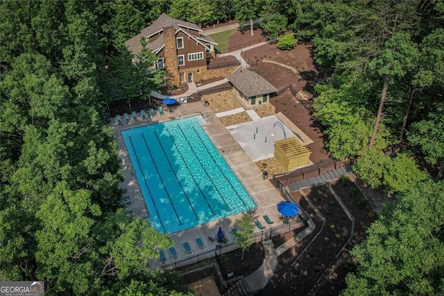 aerial view of property and surrounding area featuring a pool