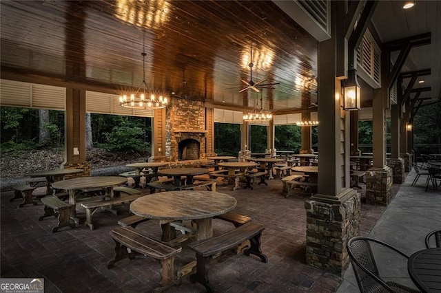 view of patio / terrace featuring an outdoor stone fireplace and ceiling fan